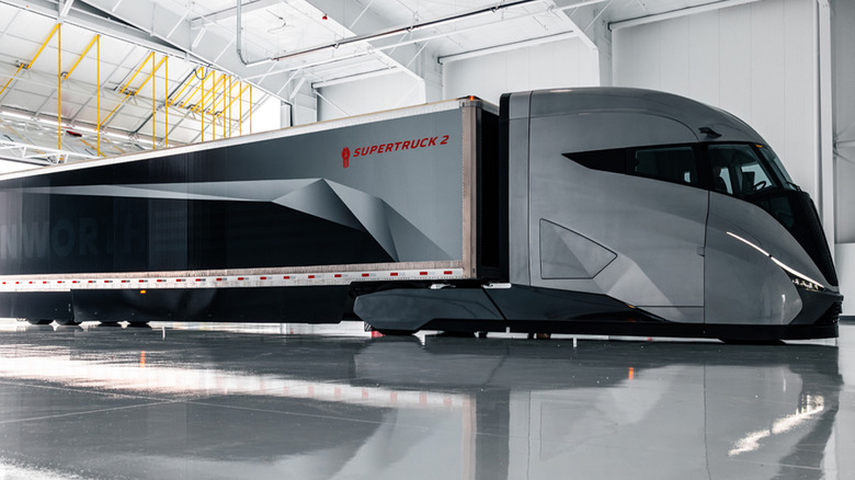 A Kenworth SuperTruck 2 semi parked in a hanger