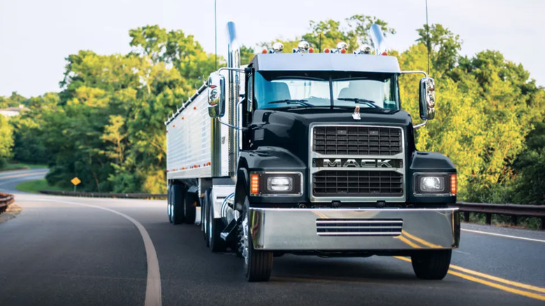 A Mack Pinnacle semi driving along a freeway