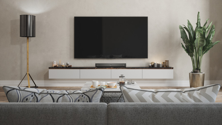 The living room with a TV and a small soundbar under it