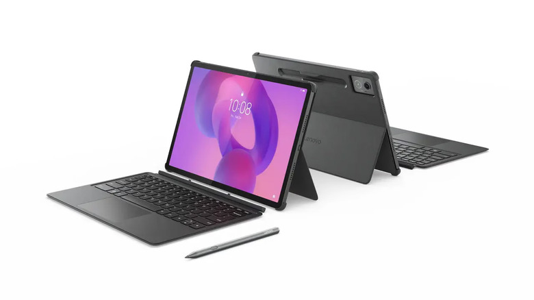 Two Lenovo Idea Tab Pro tablets with two keyboards in front of them, with a stylus next to one on a white background