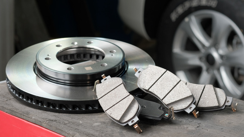A brake and brake pads on a table in a workshop.