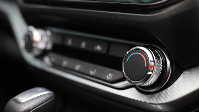 A closeup picture of a car's climate control dials.