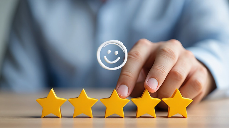 Graphic of five yellow stars and a smiley face