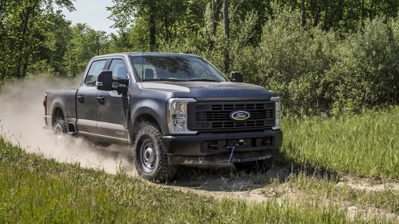 A super duty Ford truck on a dirt road