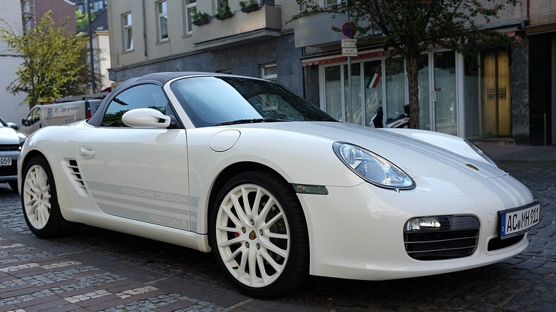 White Porsche Boxster 987 three quarter front parked on street