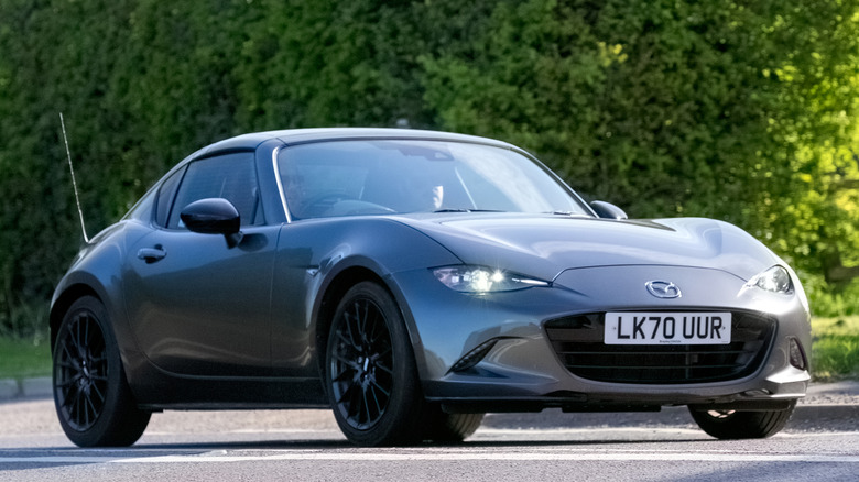 Grey 2020 mazda miata in traffic three quarter front view