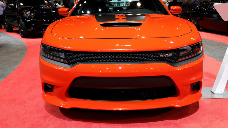 Close up of a performance fifth generation Dodge Charger's front fascia and hood at a car show.