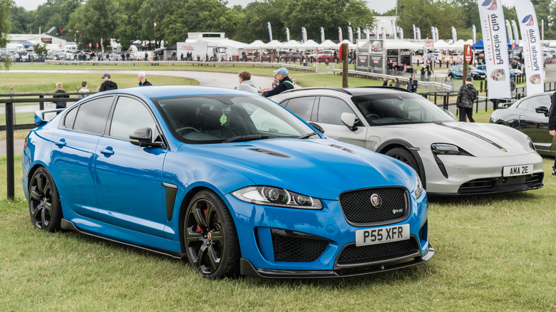 Blue Jaguar XFR sedan on grass at car show