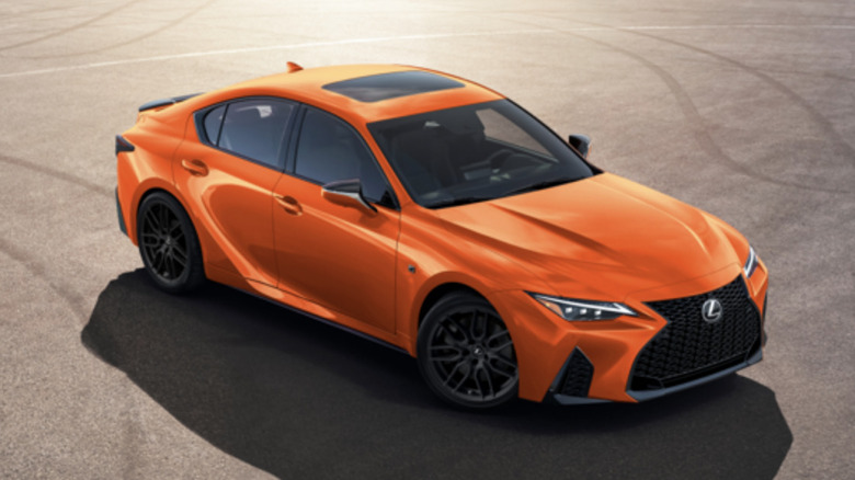 Orange Lexus IS 500 F Sport Performance front upper three quarter view parked on tarmac