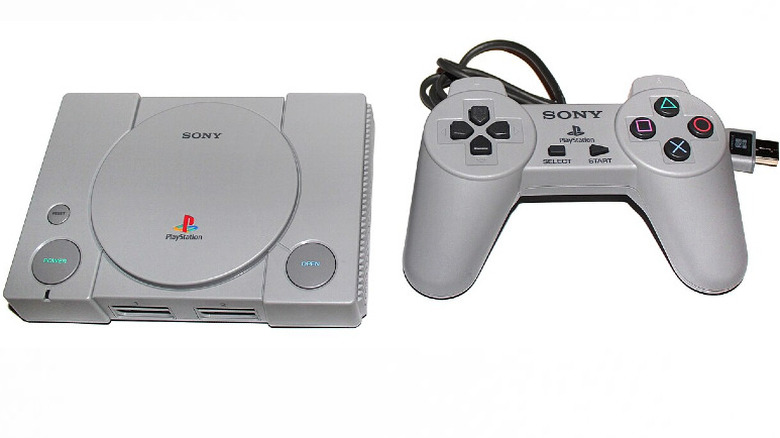 PlayStation Classic and controller against a white background, with the controller considerably bigger than the console