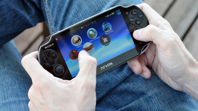 Close-up of a gamer holding a PlayStation Vita