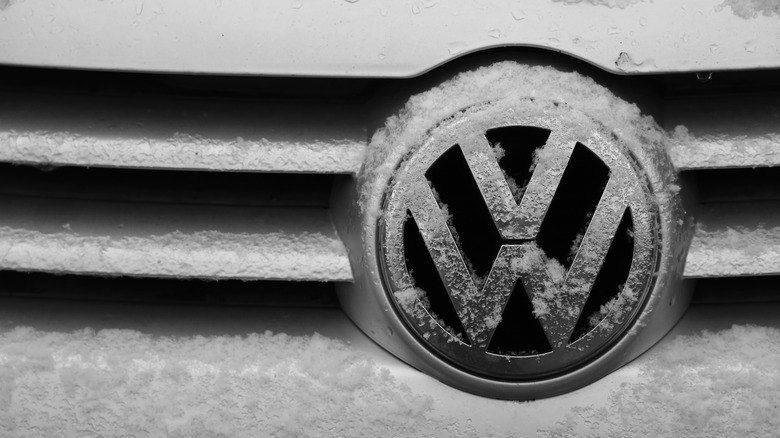 Volkswagen logo on car covered in snow