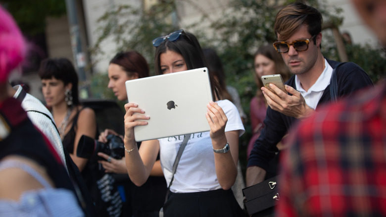 Woman holding large iPad