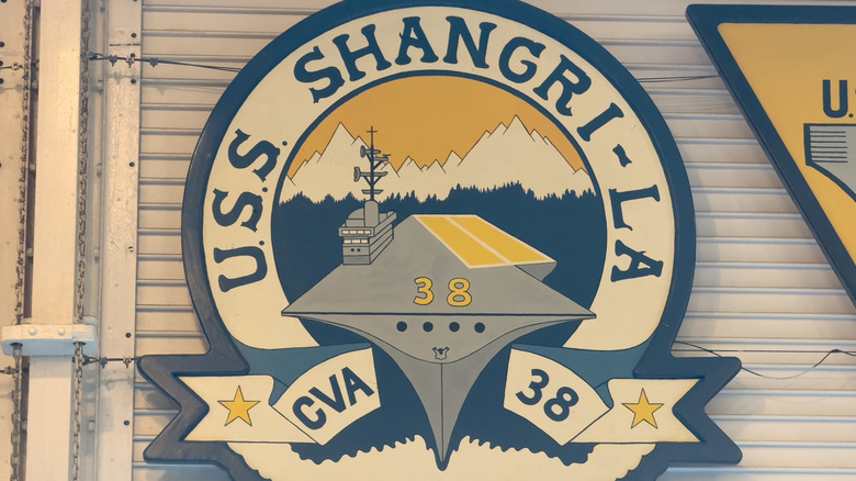 The emblem of the USS Shangri-La, mounted on the outside of a shutter.