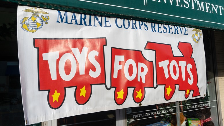 A white Toys for Tots charitable donation banner advertisement.