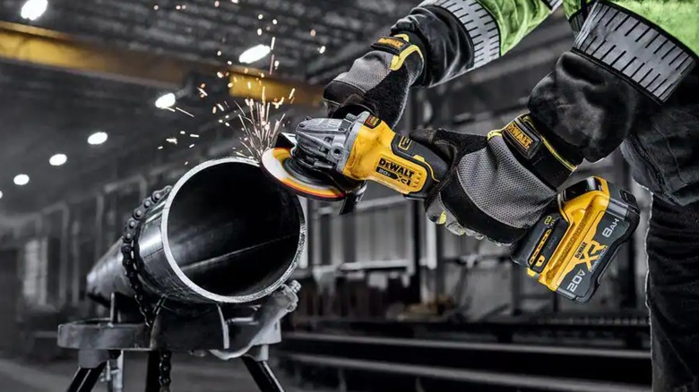 A worker using a DeWalt angle grinder.