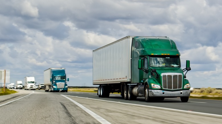 A green truck driving on Interstate 5