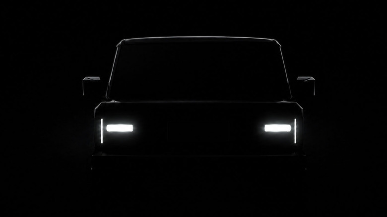 Front teaser view of REO Runabout truck on black background.