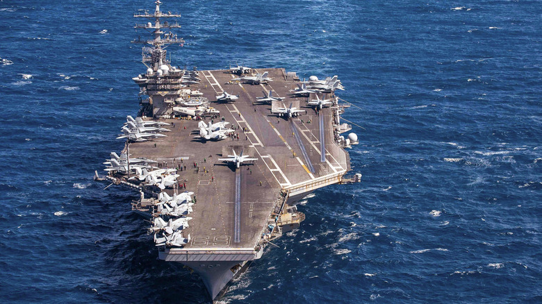 USS Dwight D. Eisenhower with several aircraft on deck.