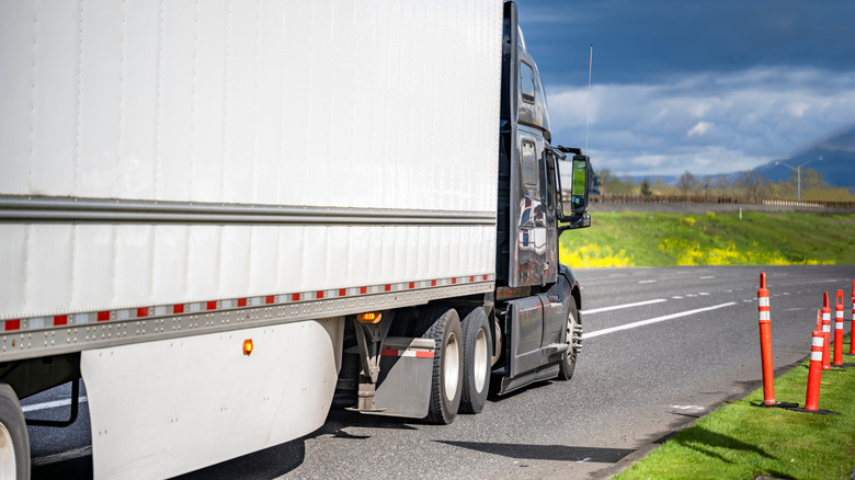 A semi-truck with side skirt on it