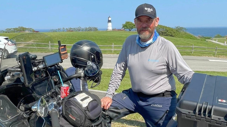 Pat Cornell with his bike on the side of the highway