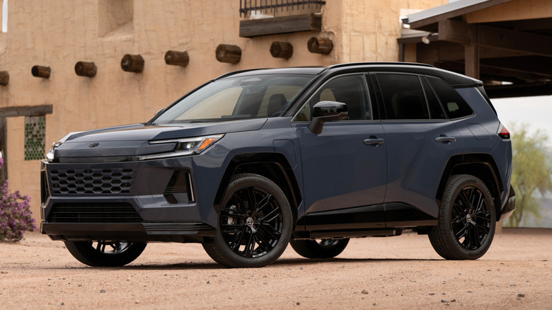 Front 3/4 view of gray Toyota RAV4 PHEV parked in desert.