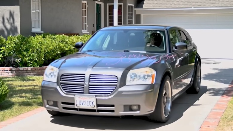 Dodge Magnum with "LUVSICK" license plate in driveway