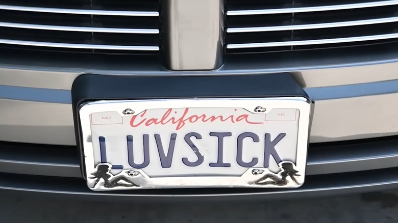 Close-up of vanity license plate reading "LUVSICK" on front of vehicle