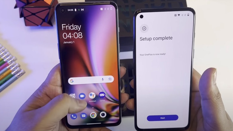 Two OnePlus phones held in hands