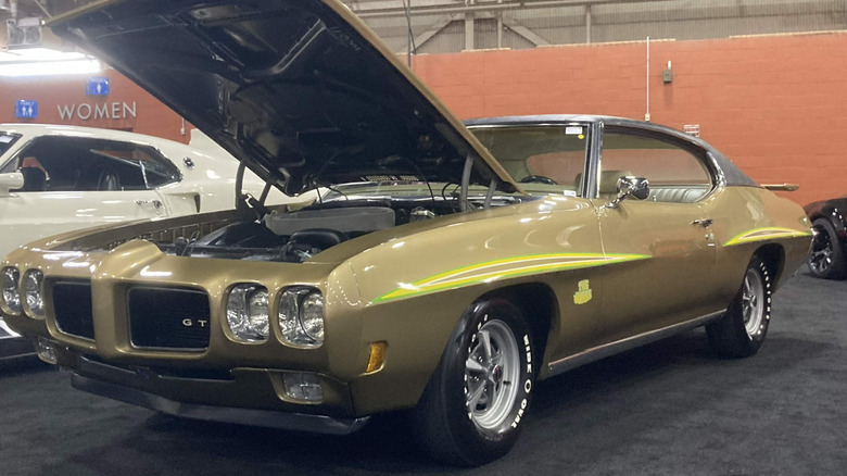 1970 Pontiac GTO with factory ram-air parked indoors, front-left 3/4 view