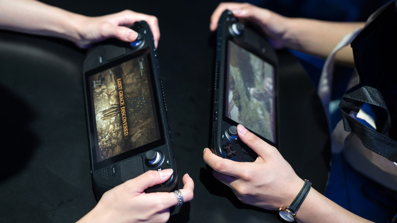 People playing Steam Deck handheld together