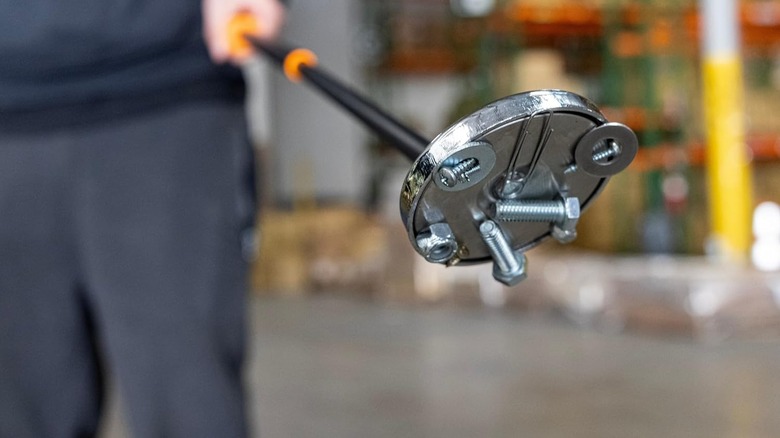 disc-shaped Neiko pickup tool with screws and washers attached.