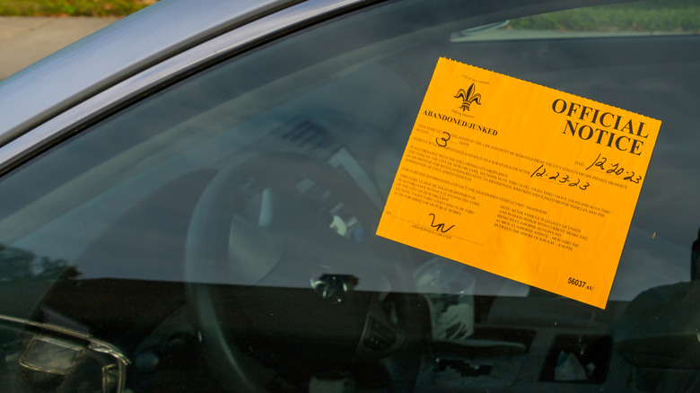 Abandoned car sticker on a car's window