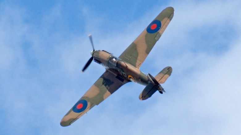 A Hawker Hurricane flying over blue, cloudy skies