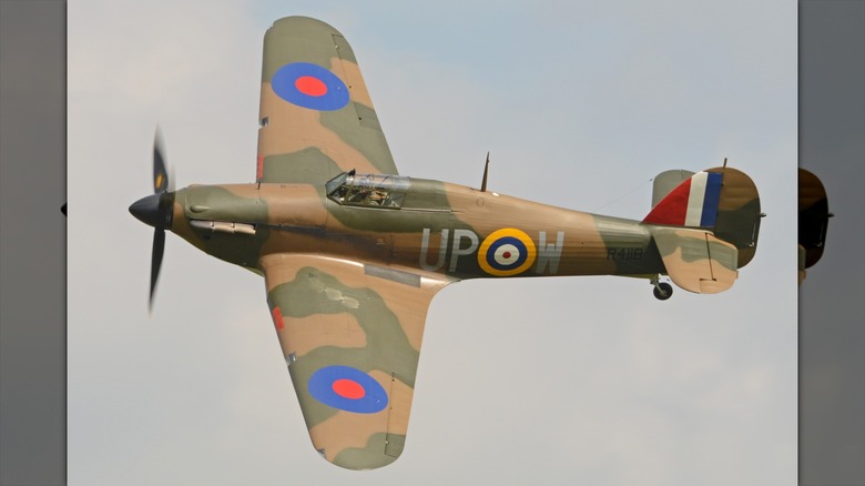 A Hawker Hurricane flying over cloudy skies