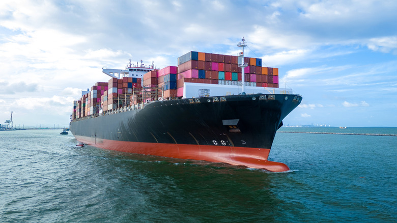 Aerial side view of cargo ship carrying containers