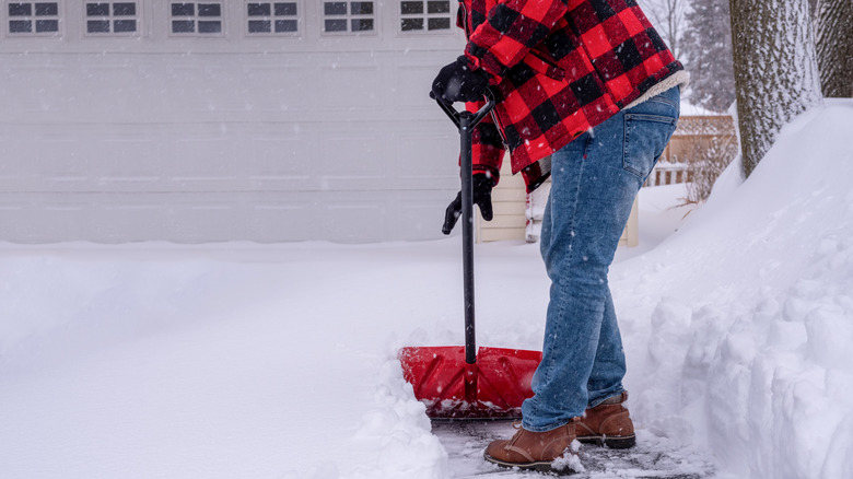 Person shovelling snowy driveway