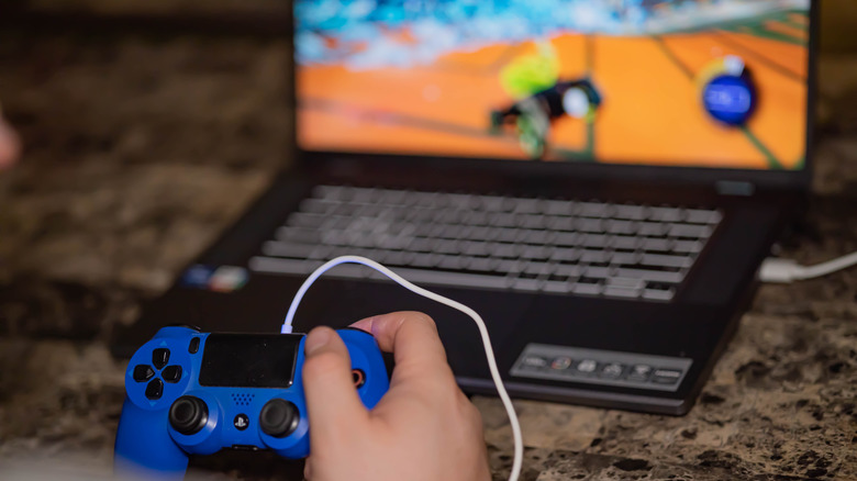 Person holding Xbox controller