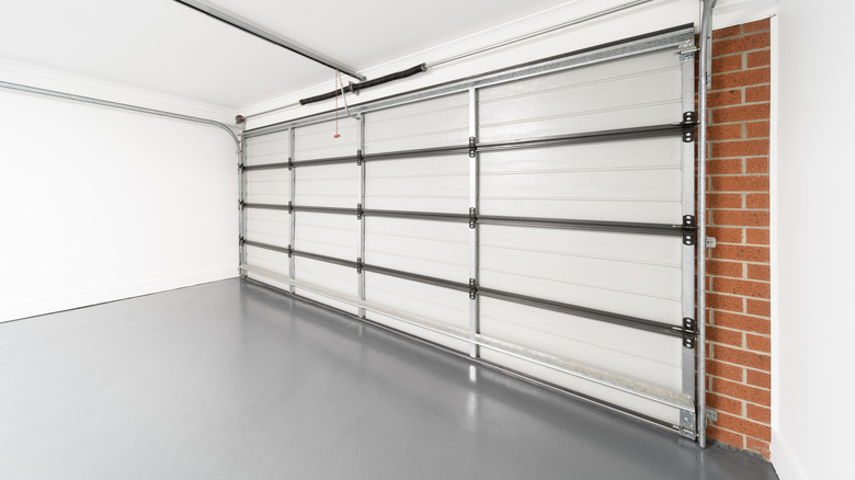 The interior of a clean garage, its door closed, with a well-kept floor