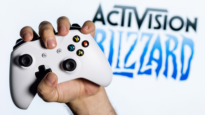 Hand gripping Xbox controller