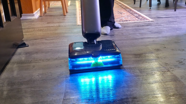 A person using the Aero Ultra Steam on grey flooring