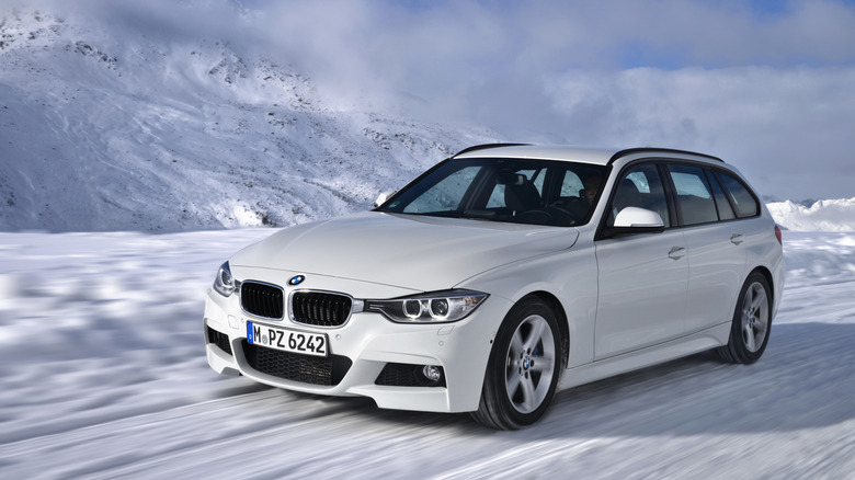 An F31 BMW 320d xDrive on the snow, front 3/4 view, white exterior