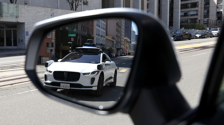 Waymo car in side mirror
