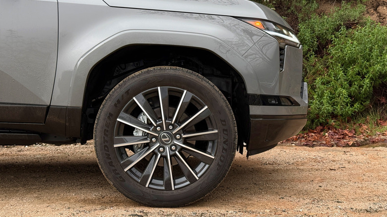 Lexus GX front wheel parked on dirt