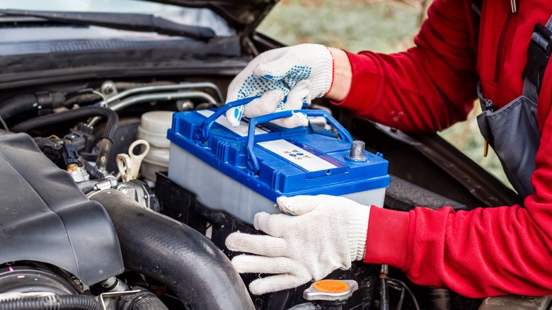 Mechanic installing new car battery