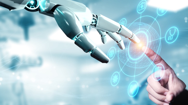 AI hand touching human hand