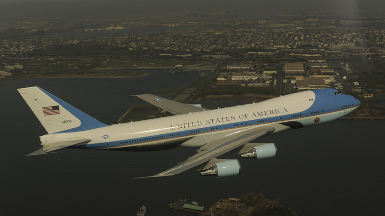 Air Force one flying over statue of liberty