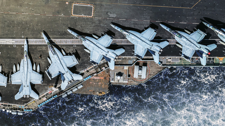 fighter jets on an aircraft carrier