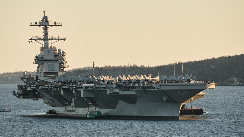 The USS Gerald R. Ford sailing close to a shoreline