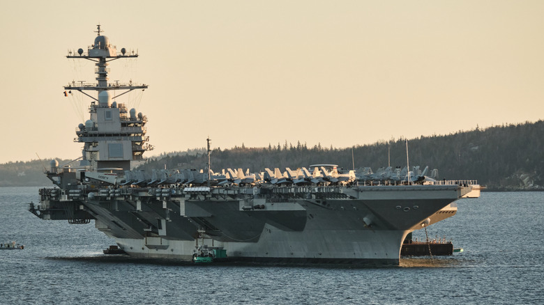 The USS Gerald R. Ford sailing close to a shoreline